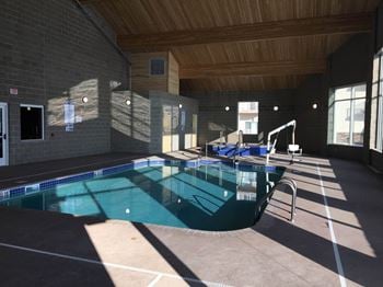A large indoor swimming pool with a wooden ceiling